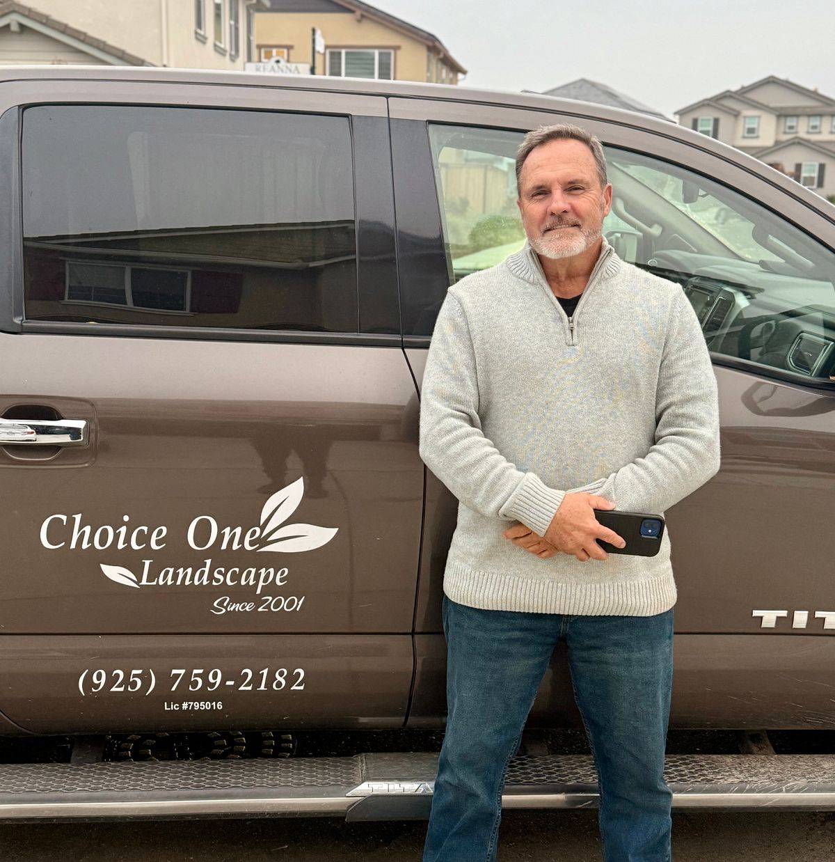 Greg Smith, founder of Choice One Landscape, beside the company truck